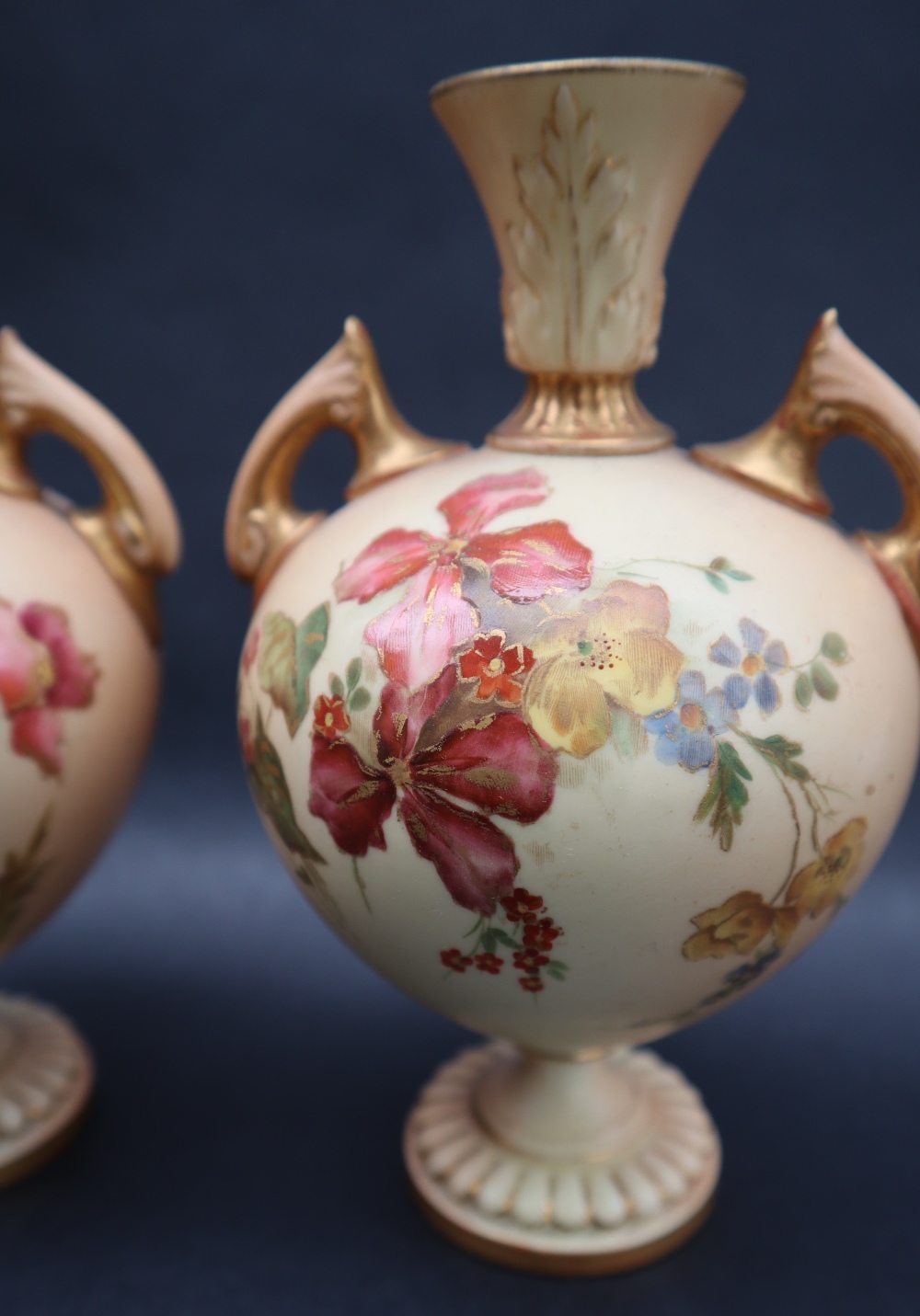 A pair of Royal Worcester porcelain twin handled vases transfer and infill decorated with flowers - Image 3 of 5