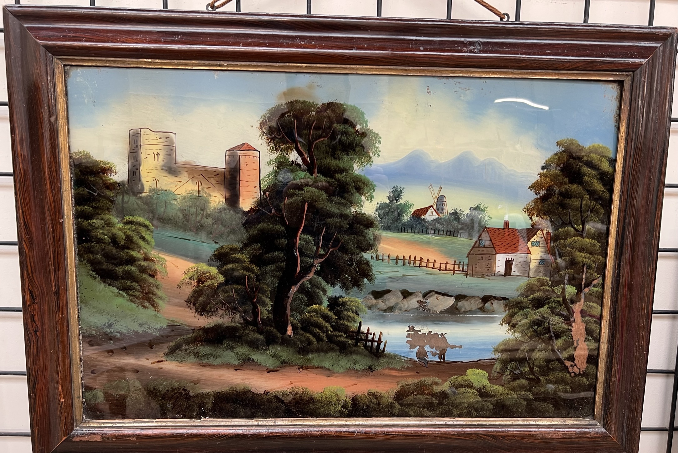 A reverse painting on glass of a castle on a hill