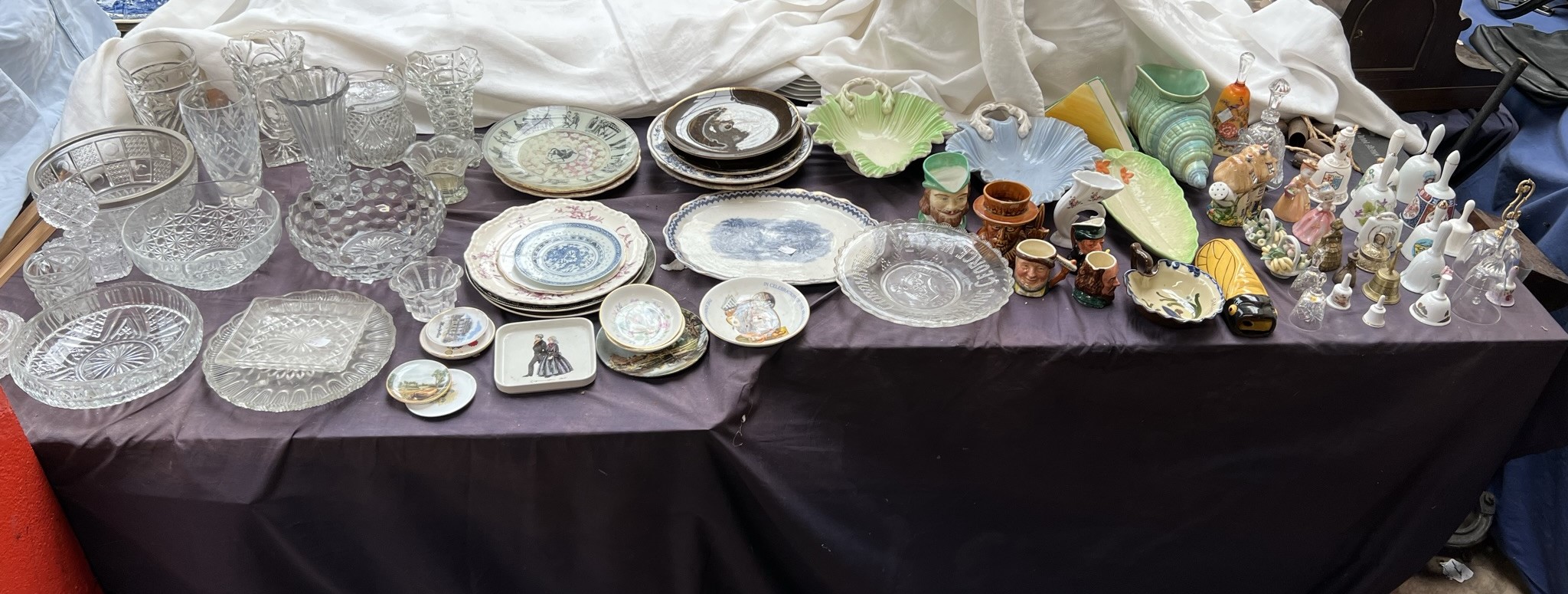 A large lot including a shell vase by Shorter together with a collection of bells, plates,
