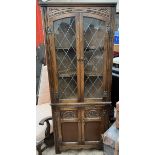 An oak standing corner cupboard with leaded glazed doors