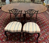 A reproduction mahogany extending dining table together with a pair of Edwardian mahogany salon