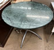 A green veined marble circular dining table on a brushed steel base,