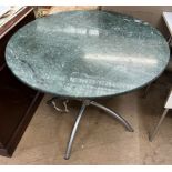 A green veined marble circular dining table on a brushed steel base,