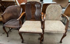 A burr walnut bergere elbow chair together with another bergere armchair and a bergere tub chair