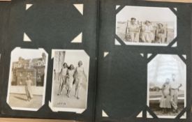 A Postcard album containing circa 220 mainly photographic cards,