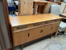 A mid 20th century G-Plan teak sideboard of rectangular form with four drawers and four cupboards