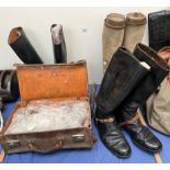 Three pairs of riding boots together with a leather suitcase