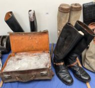 Three pairs of riding boots together with a leather suitcase