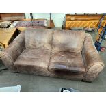 A brown leather two seater settee