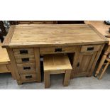 A modern oak desk with six drawers and a cupboard together with a similar side table