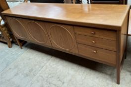 A mid 20th century teak sideboard with a drop front cabinet,