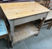 A pine side table with a rectangular planked top above a shelf with drawer on turned uprights and