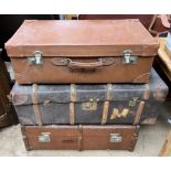 A leather suitcase together with two cabin trunks