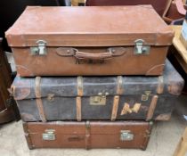 A leather suitcase together with two cabin trunks
