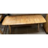 An Ercol coffee table of rectangular form on tapering legs,