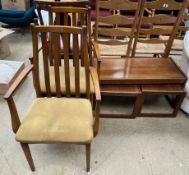 A mid 20th century teak nest of three tables together with a pair of slat back dining chairs