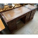 A reproduction mahogany pedestal desk with leather inset top together with a matching filing unit
