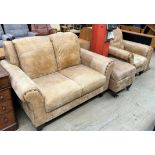 A brown leather two seater settee together with a matching arm chair and foot stool