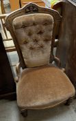 A late Victorian walnut framed nursing chair with button back upholstery and a pad seat on turned