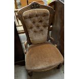 A late Victorian walnut framed nursing chair with button back upholstery and a pad seat on turned