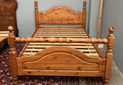 A pine double bed with an arched head and foot board