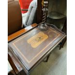 An Edwardian mahogany twin handled gallery tray, inlaid with musical instruments,