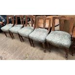 A set of five Victorian dining chairs with carved dished back above a pad seat on turned front legs