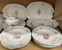 An Emil Fischer of Budapest porcelain part dinner set decorated with sprays of garden flowers