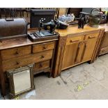 An oak chest of drawers together with an oak sideboard, cased Singer sewing machine,
