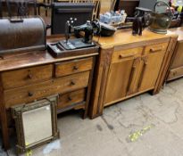 An oak chest of drawers together with an oak sideboard, cased Singer sewing machine,