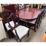 A reproduction mahogany extending dining table and six chairs