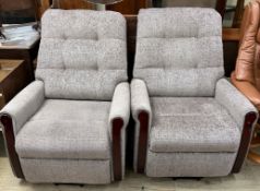 A pair of upholstered reclining chairs