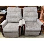 A pair of upholstered reclining chairs