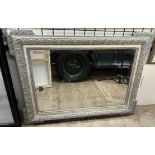 A grey and cream painted wall mirror,