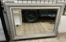 A grey and cream painted wall mirror,