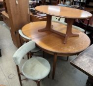 A mid-20th century G-Plan teak extending dining table and chairs,