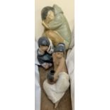 A large Lladro model of a sleeping Eskimo boy together with another Eskimo figure and another