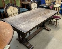 An oak refectory table together with a pair of shield back chairs,