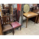 An oak dining table of rectangular form together with two dining chairs, a brass tray top table,