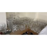 An extensive collection of crystal drinking glasses, crystal vases, decanters, desk clock,