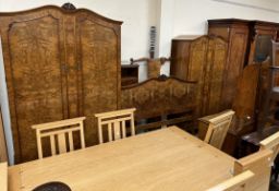 An early 20th century burr walnut bedroom suite comprising two wardrobes,
