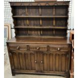 A 20th century oak dresser with a moulded cornice and two shelves,