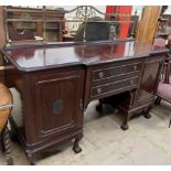 An early 20th century mahogany pedestal sideboard with a brass gallery above two central drawers