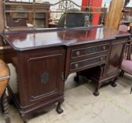 An early 20th century mahogany pedestal sideboard with a brass gallery above two central drawers