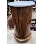 A Victorian mahogany pot cupboard with a circular marble top above a cylindrical body with a single