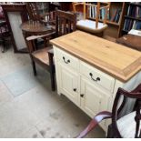 A cream painted dresser base together with an oak elbow chair,