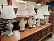 A pair of pottery table lamps together with five other table lamps and an onyx ashtray