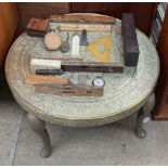 A brass topped table together with assorted wood working levels, rule, hip flask,