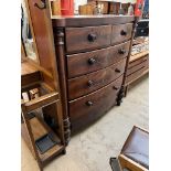 A Victorian mahogany chest with a D shaped top above two short and three long drawers on turned