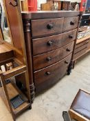 A Victorian mahogany chest with a D shaped top above two short and three long drawers on turned